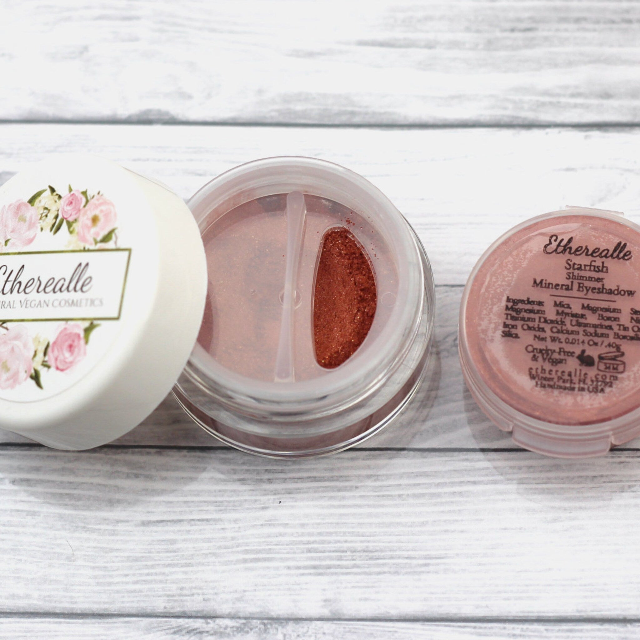 Mineral eyeshadow in open clear container with bronze shimmer and Etherealle label