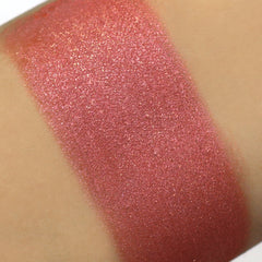 Glitter eyeshadow swatch in pink with shimmer applied on skin