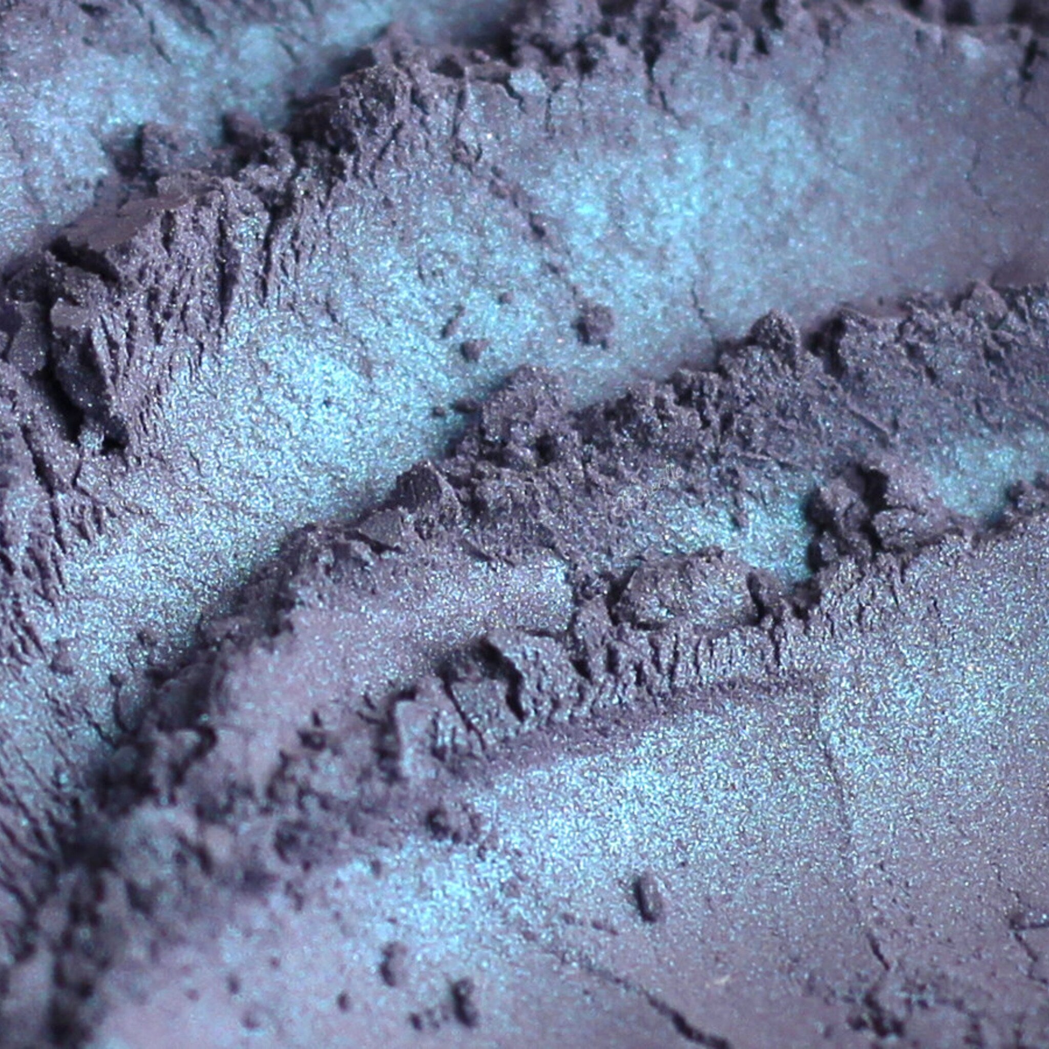 Powder eyeshadow, iridescent blue and purple, with textured surface