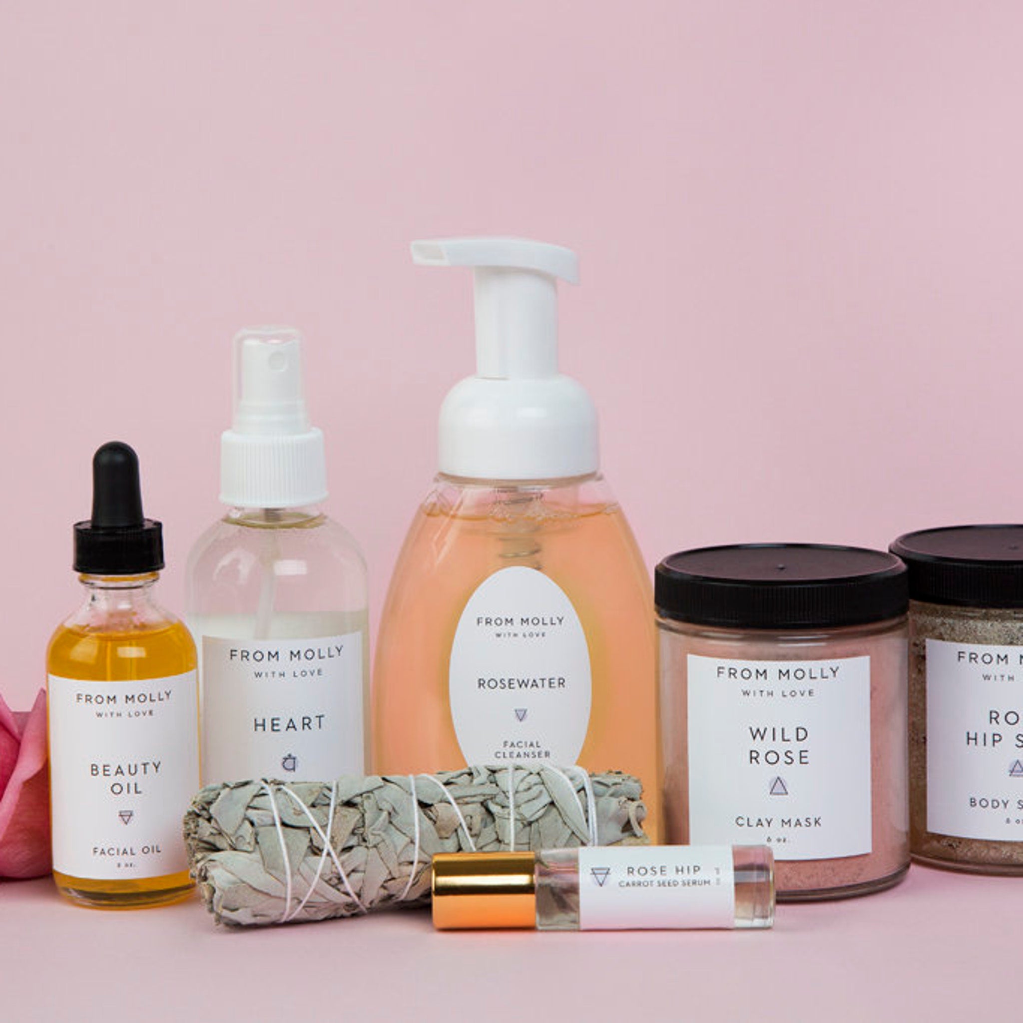 Skincare products in various containers, including glass bottles and jars, with "From Molly" labels on a pink background