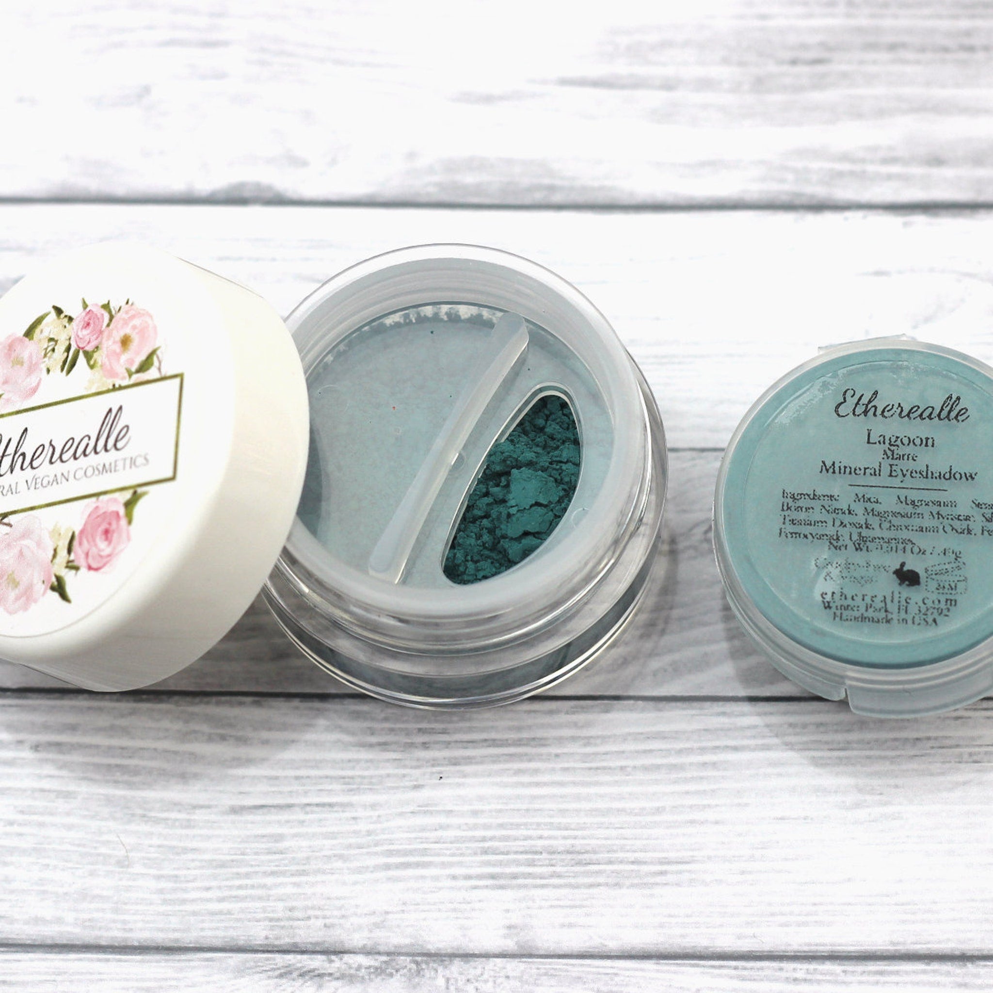 Eyeshadow powder in teal and dark green, clear plastic containers, Etherealle brand