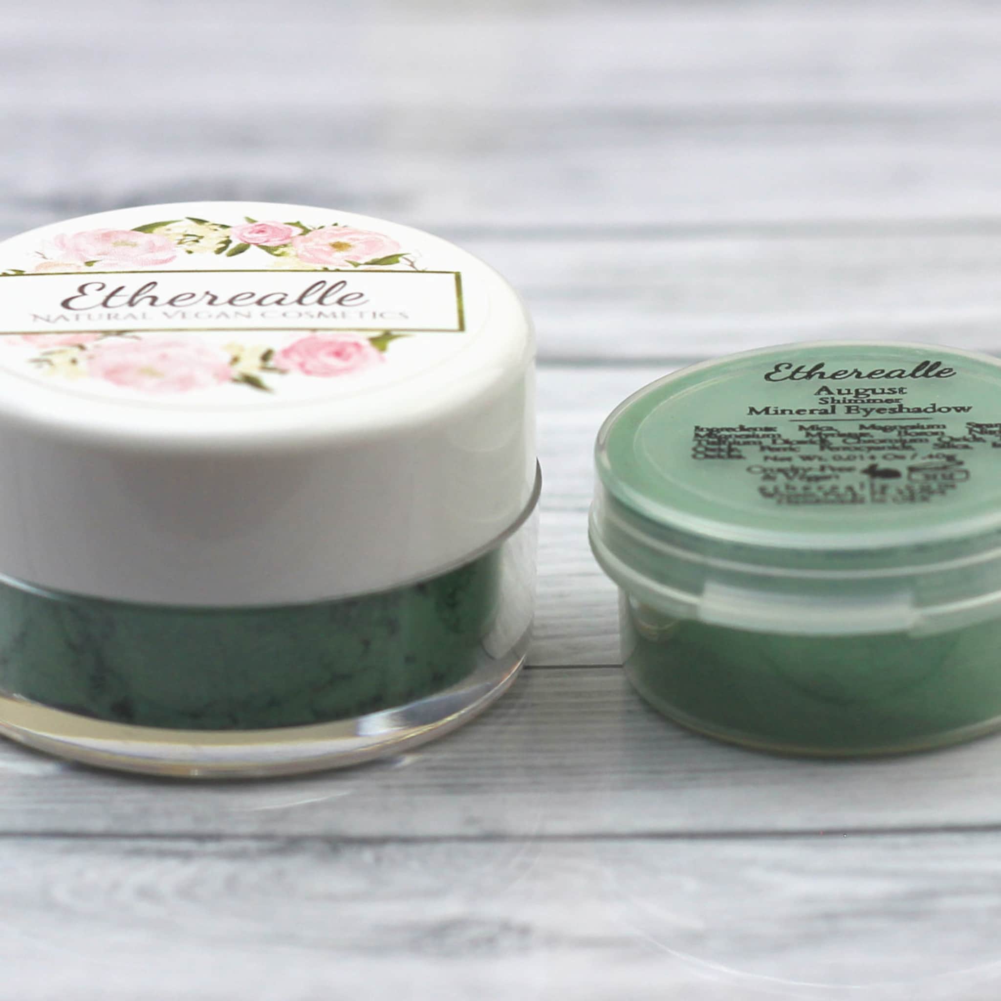 Eyeshadow jars with white and green lids, floral label, and Etherealle brand text