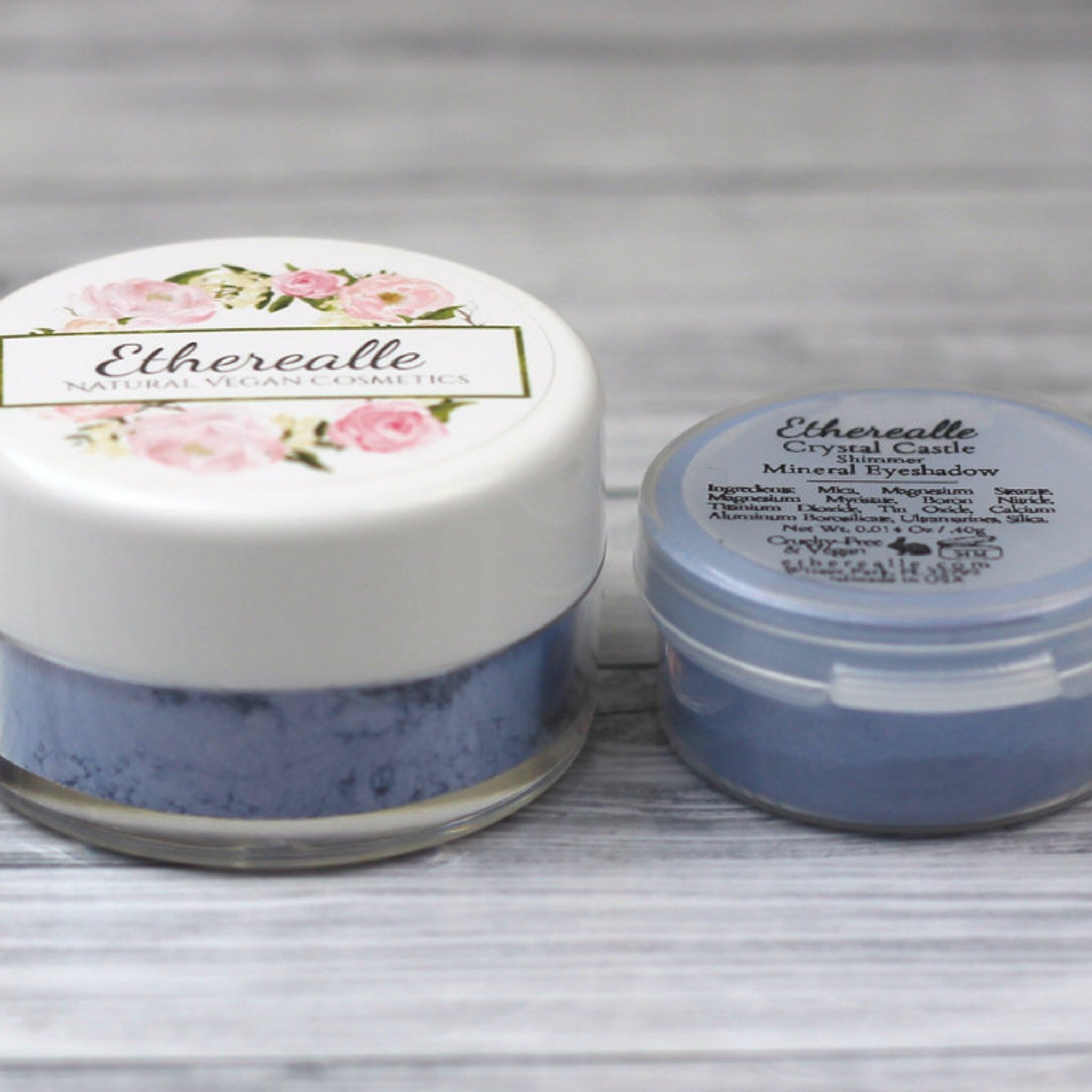 Open compact showing vegan mineral eyeshadow in shimmering blue with pink and turquoise flecks