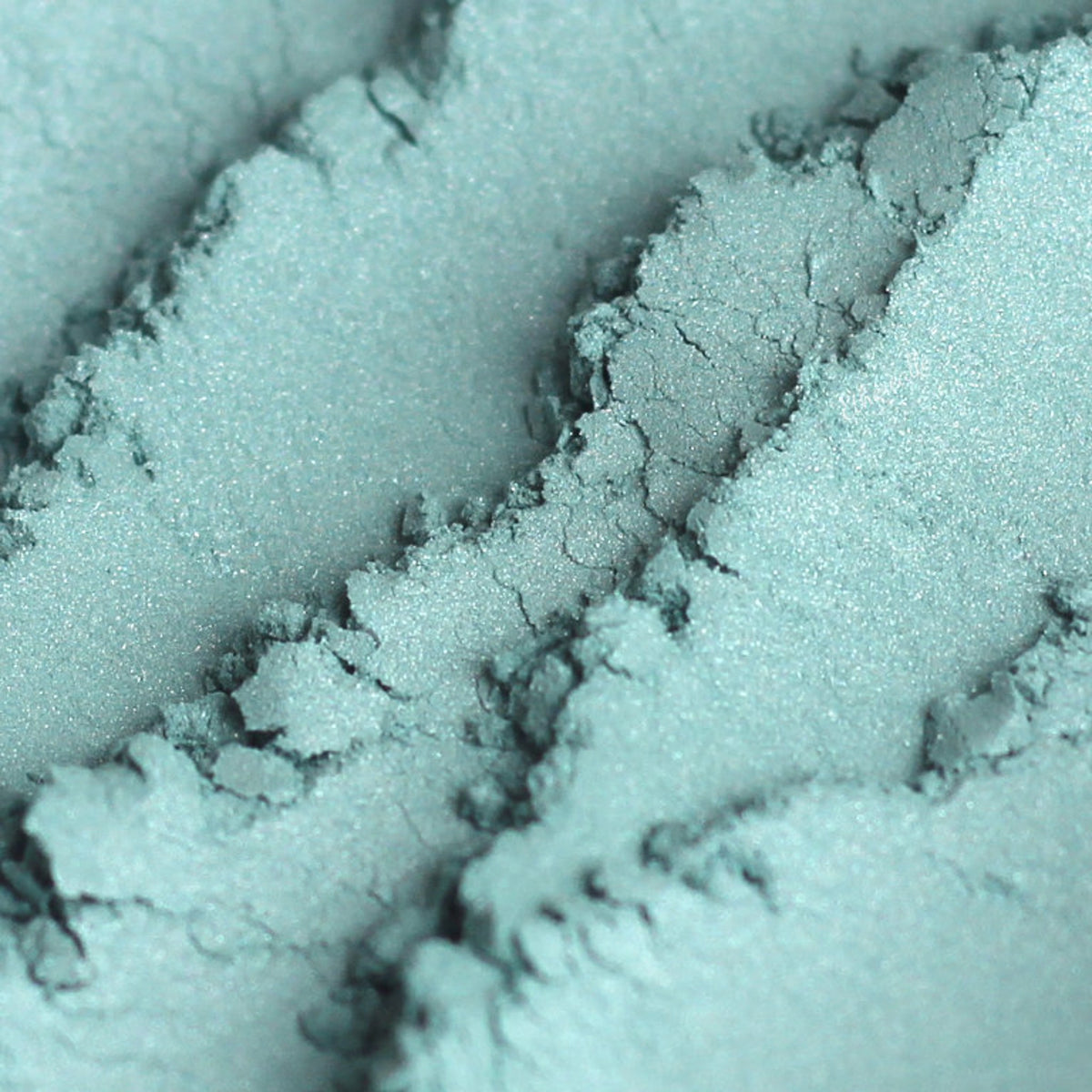 Frosty aqua blue mineral eyeshadow in shimmer finish, vegan and cruelty-free, shown in compact pan.