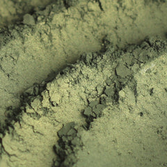 Eyeshadow, green and gold shimmer, textured powder with visible sparkle