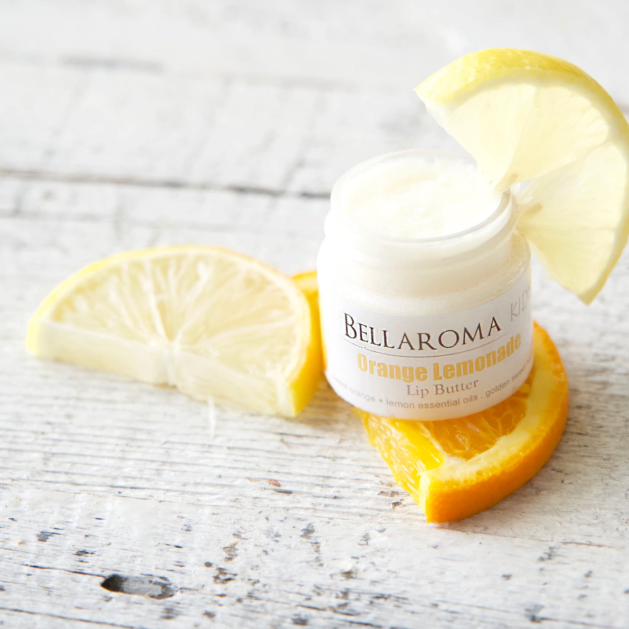 Lip butter jar with white label, orange and yellow fruit slices, BellaRoma Boutique branding