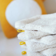 Close-up of organic cotton sponge wipe showing soft, textured surface for gentle skincare cleansing