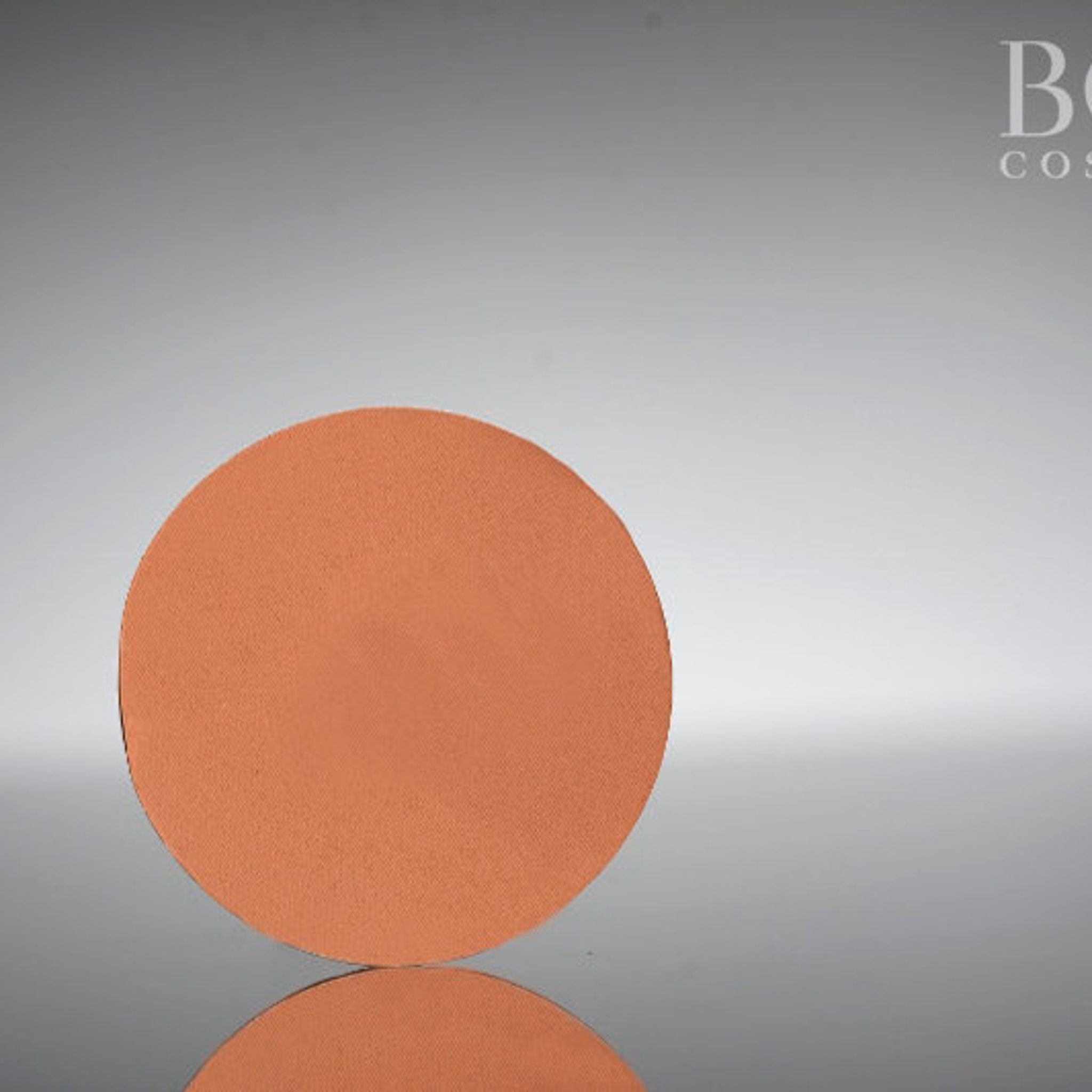 Single matte eyeshadow pan in warm chic orange-brown shade with smooth pressed powder finish