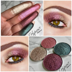 Close-up of duochrome foiled eyeshadow pan in cerise, showing metallic pink and gold shift on smooth surface