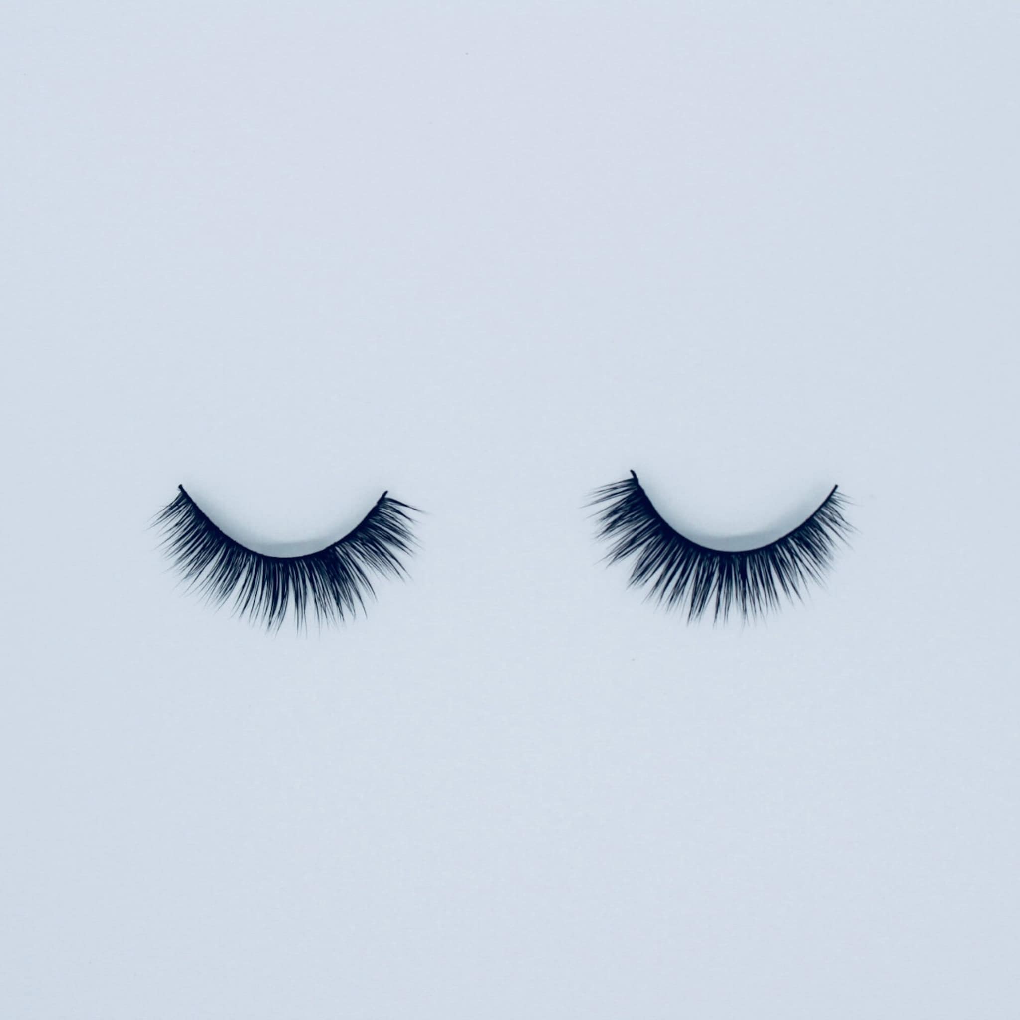 False eyelashes with black synthetic fibers, curved style on white background