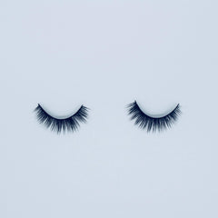 False eyelashes with black synthetic fibers, curved style on white background