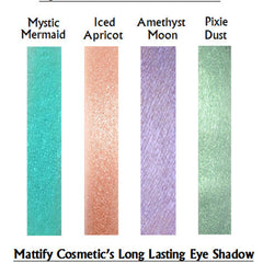 Close-up of iridescent teal and purple eyeshadow with sparkling glitter particles in compact pan