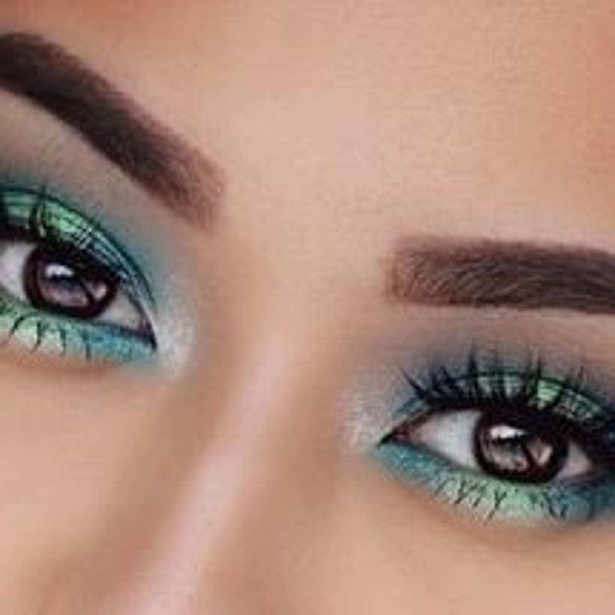 Close-up of iridescent teal and purple mermaid eyeshadow with sparkling glitter particles