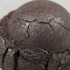 Eyeshadow, dark brown with glitter, cracked texture, close-up view