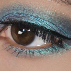 Eye makeup blue turquoise duochrome eyeshadow applied to eyelid with lashes visible