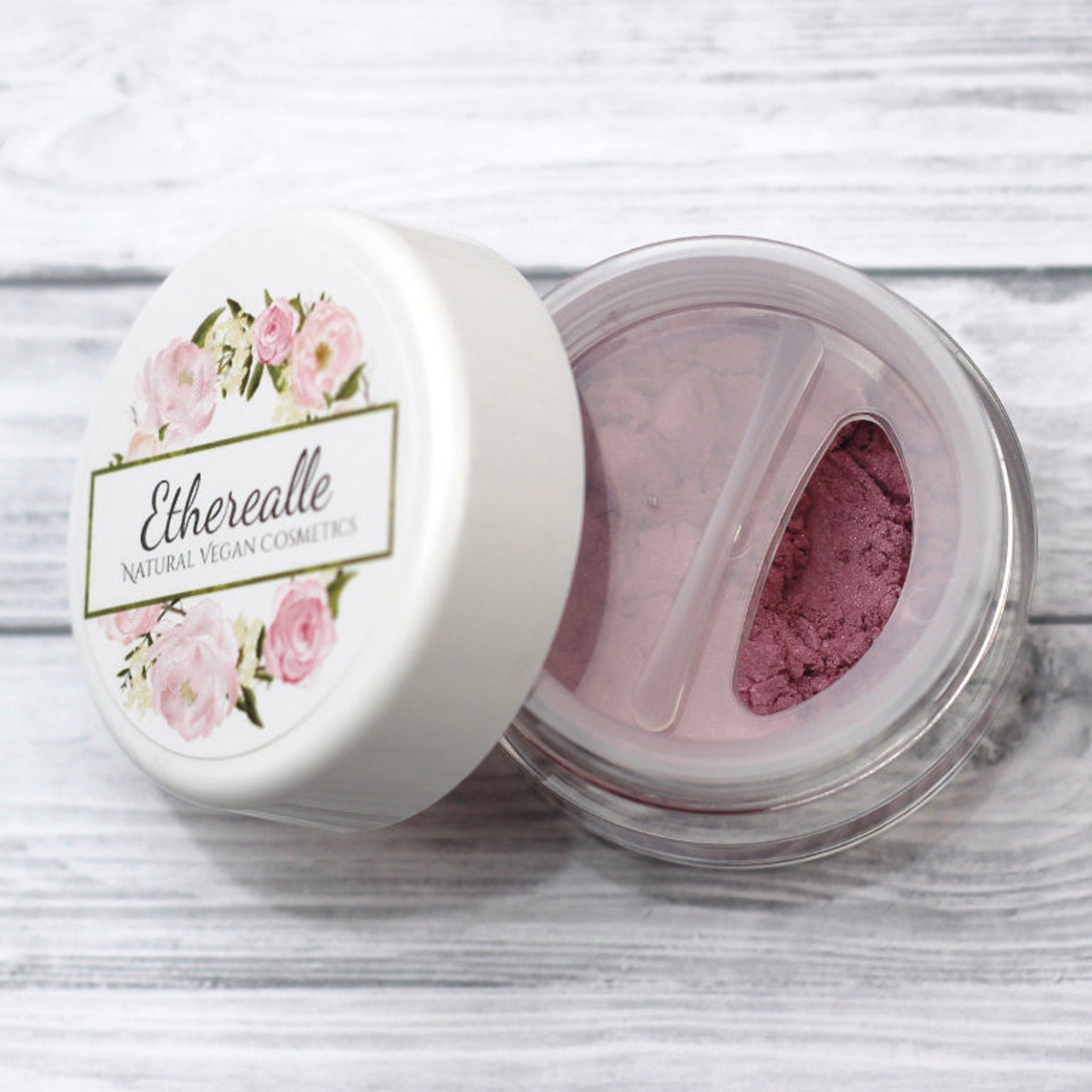 Pixie Vegan Mineral Eyeshadow compact in rose with pink and turquoise shimmer, displayed open on marble surface