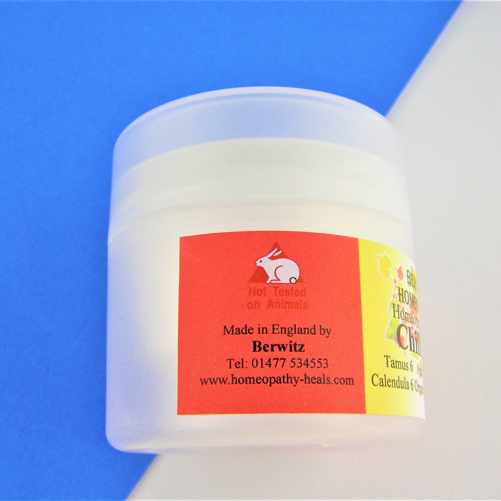 Cream jar with white plastic container, red and yellow label, and Berwitz text