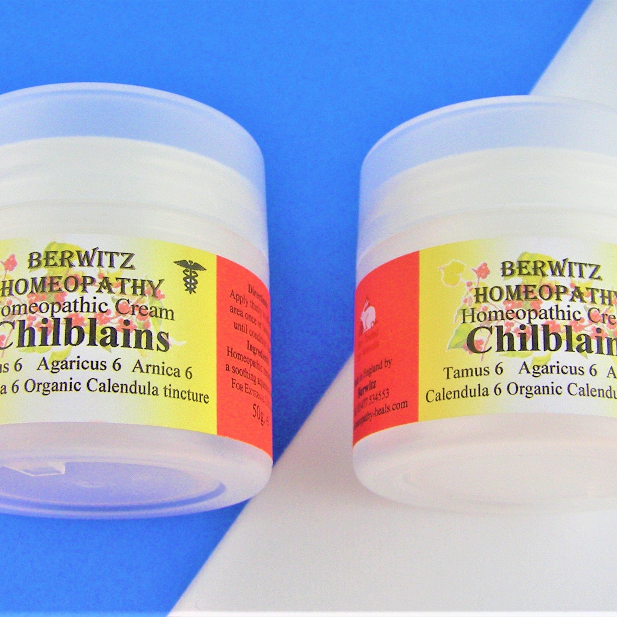 Homeopathic cream jars, white plastic containers with yellow and red labels, BERWITZ HOMEOPATHY branding