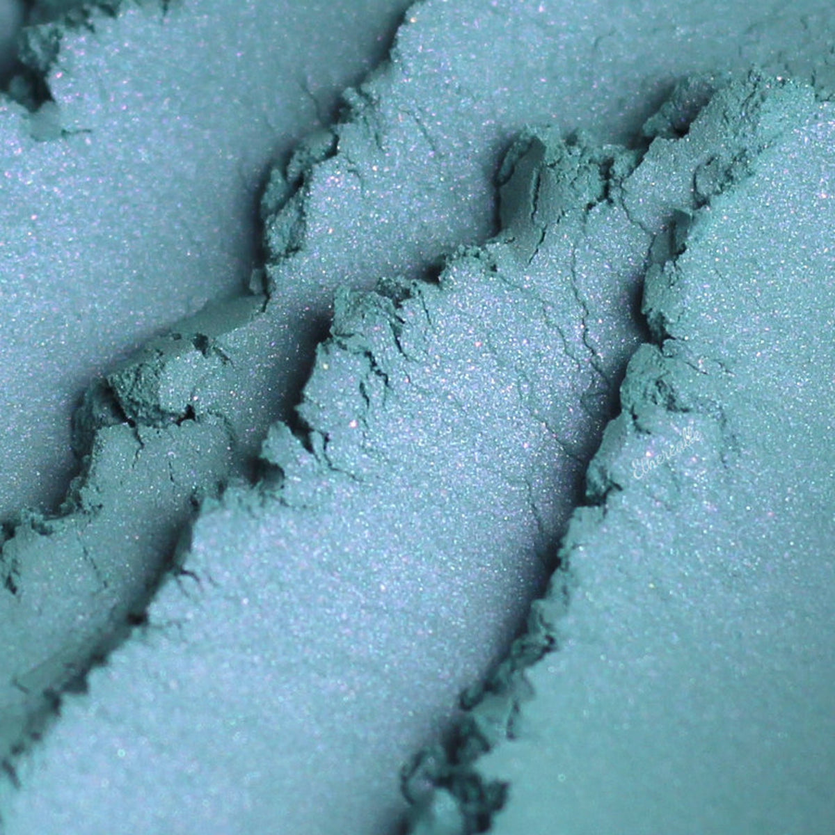 Vibrant blue mineral eyeshadow with purple duochrome shift in compact pan, vegan formula