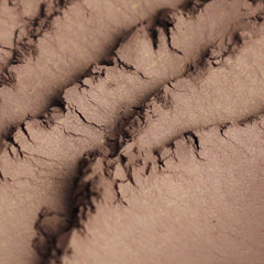 Close-up of deep brown vegan mineral eyeshadow with subtle shimmer in compact case