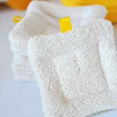 Soft organic cotton sponge wipe gently gliding across moisturized cheek during skincare routine