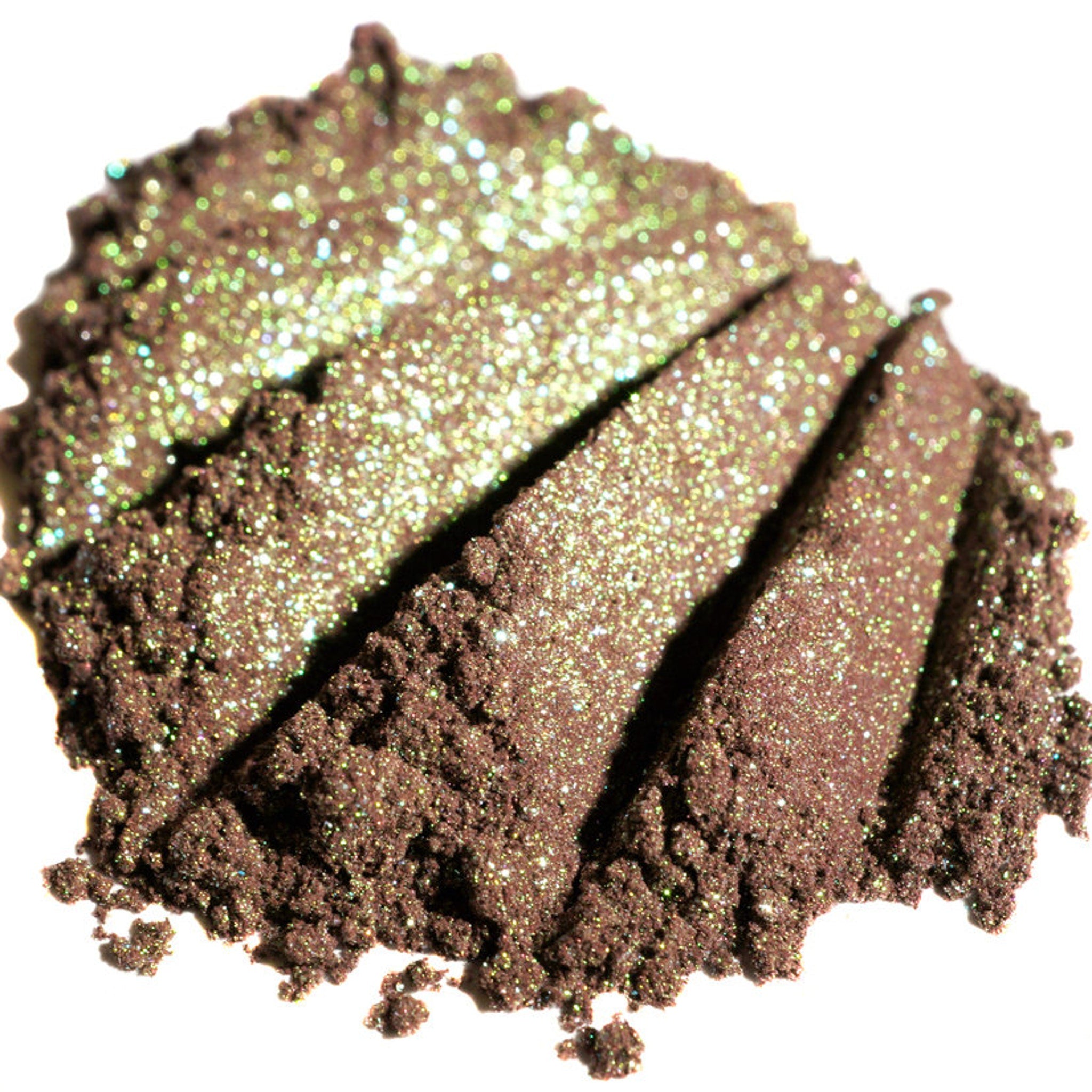 Close-up of fingertips applying duochrome green-brown eyeshadow with burgundy base and iridescent shimmer