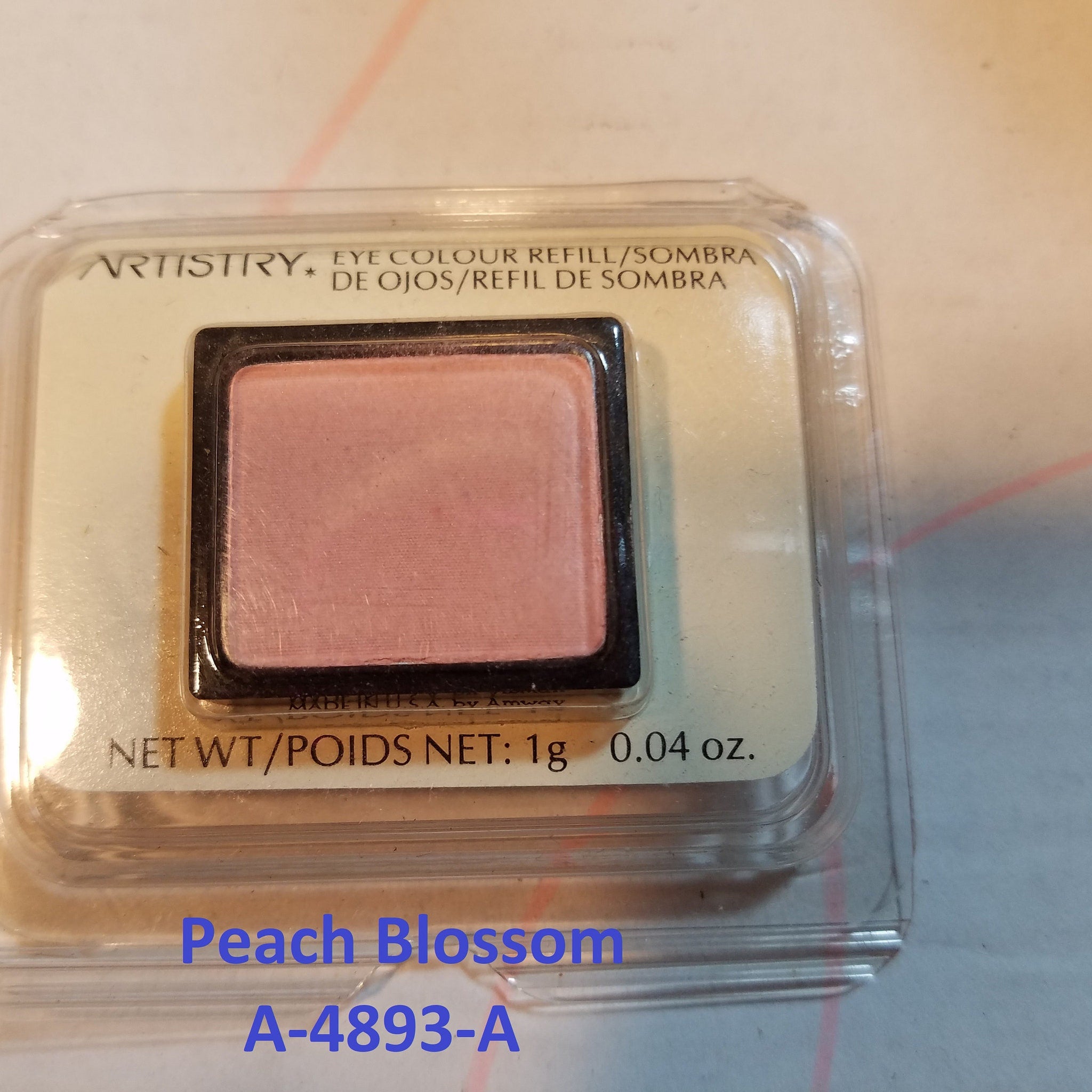 Close-up of makeup brush applying shimmering pink eye shadow to eyelid with blending motion