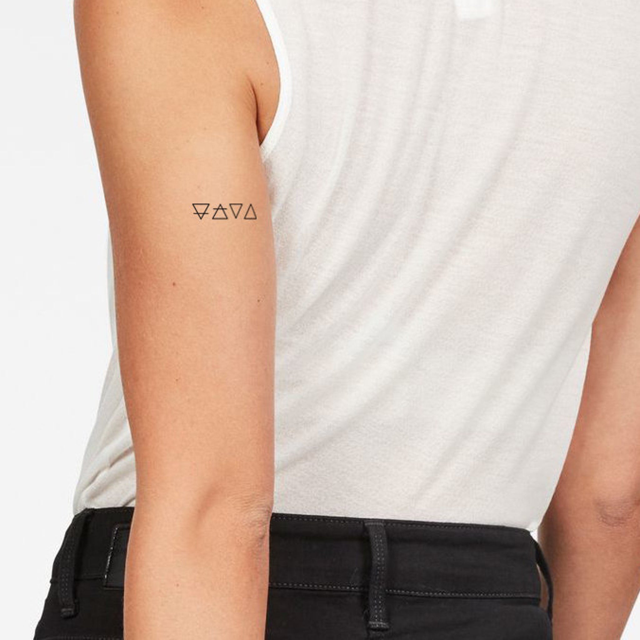 Temporary tattoos, black geometric symbols on arm, skin tone visible