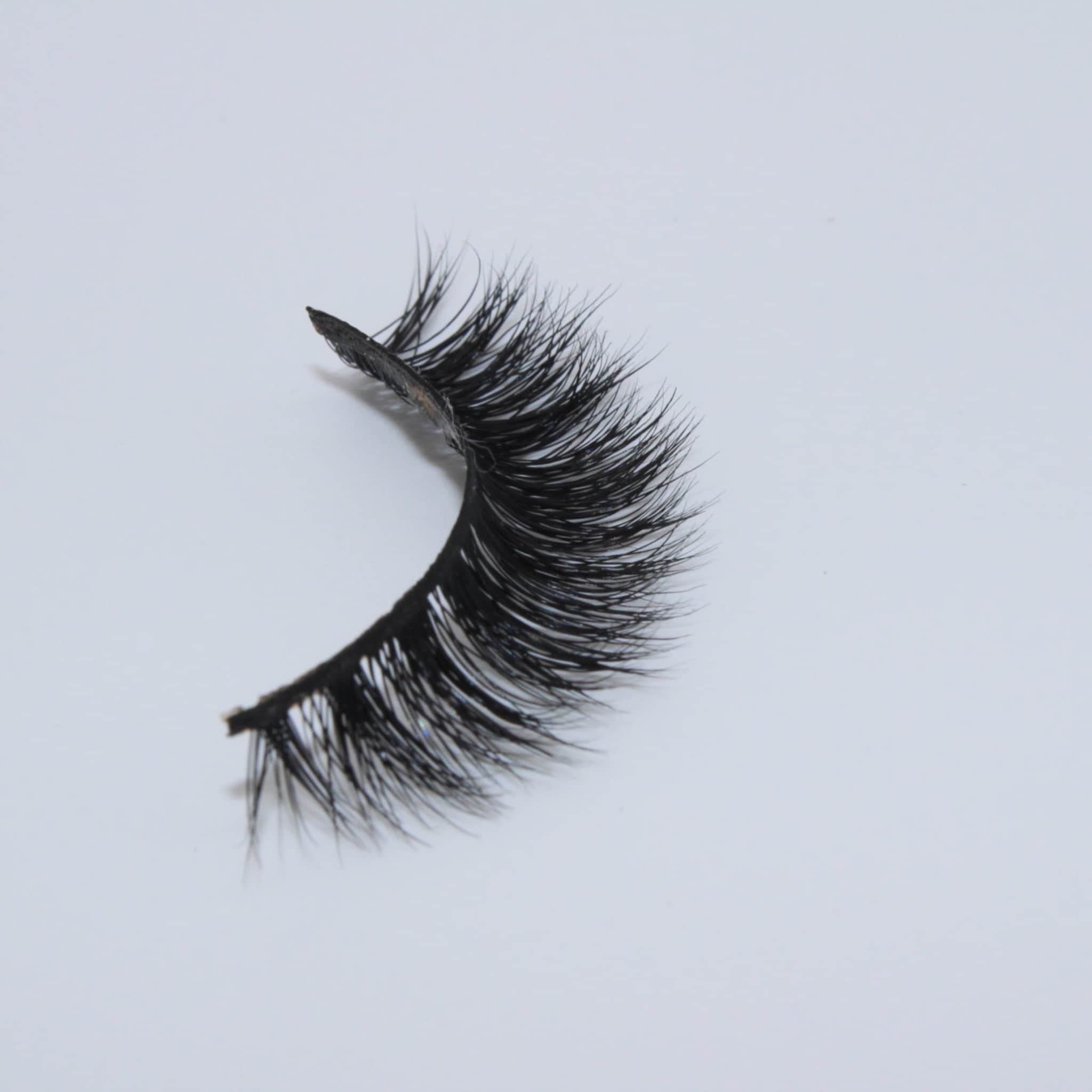 False eyelashes with black synthetic fibers and curved style on white background