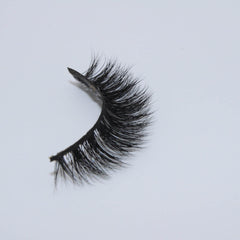 False eyelashes with black synthetic fibers and curved style on white background