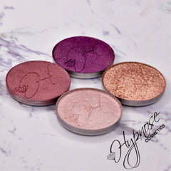 Close-up of amethyst duochrome eyeshadow pan showing foiled purple and pink shimmer in natural light