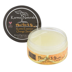 Orange scrub jar with clear glass, yellow contents, and Karma Naturals branding