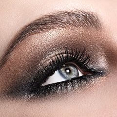Eye makeup with brown eyeshadow, black mascara, and a shimmering effect on the eyelid