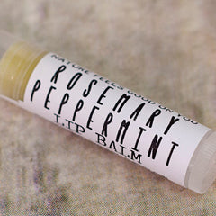 Lip balm tube with white label and black text, on textured background, Redbarn Botanicals