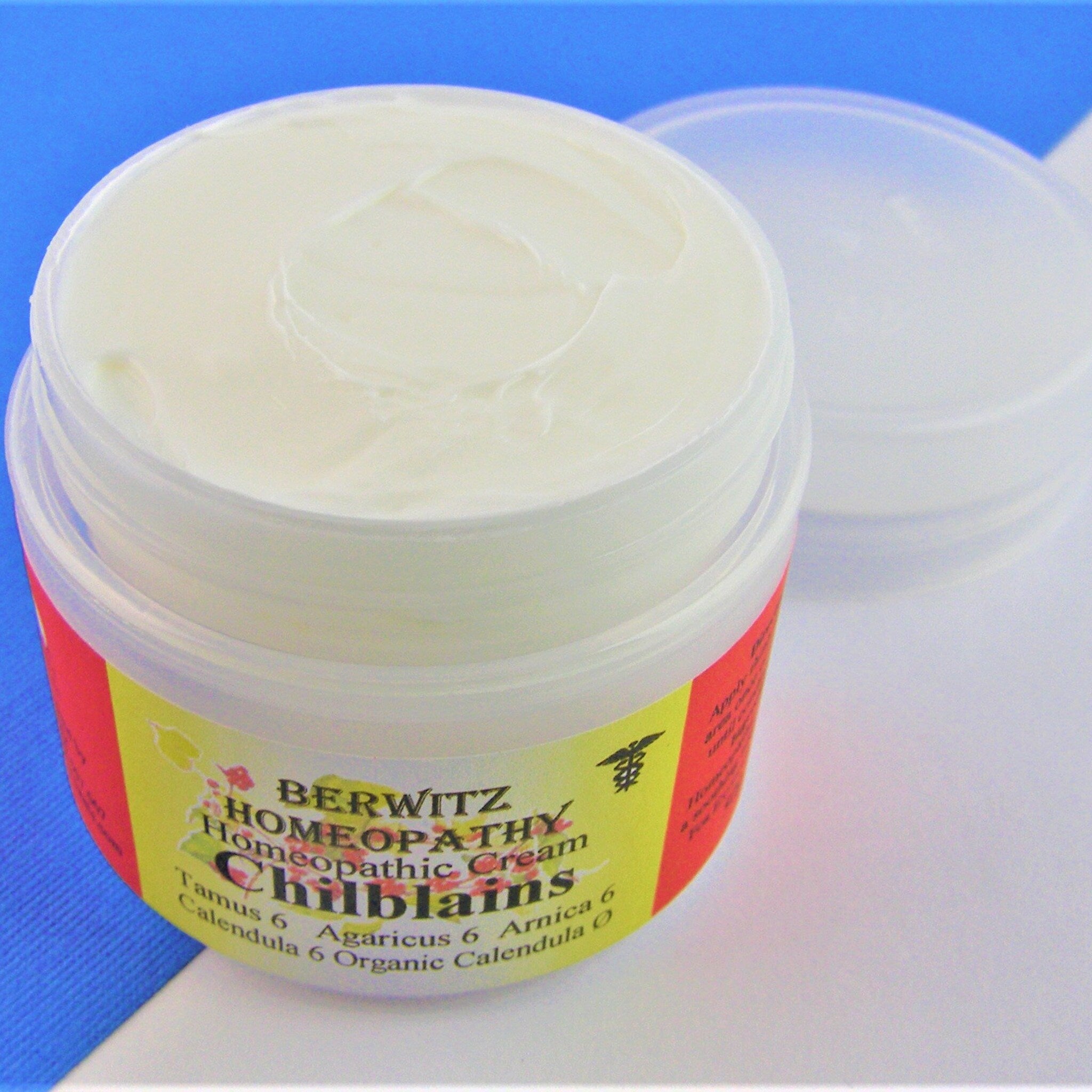 Homeopathic cream in clear plastic jar, white cream, Berwitz label visible