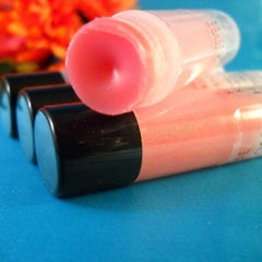 Lip gloss tubes with pink gloss, black caps, and clear plastic packaging