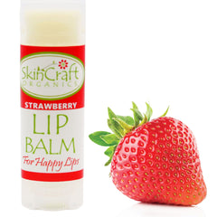 Lip balm tube with red and white label, and a red strawberry fruit beside it