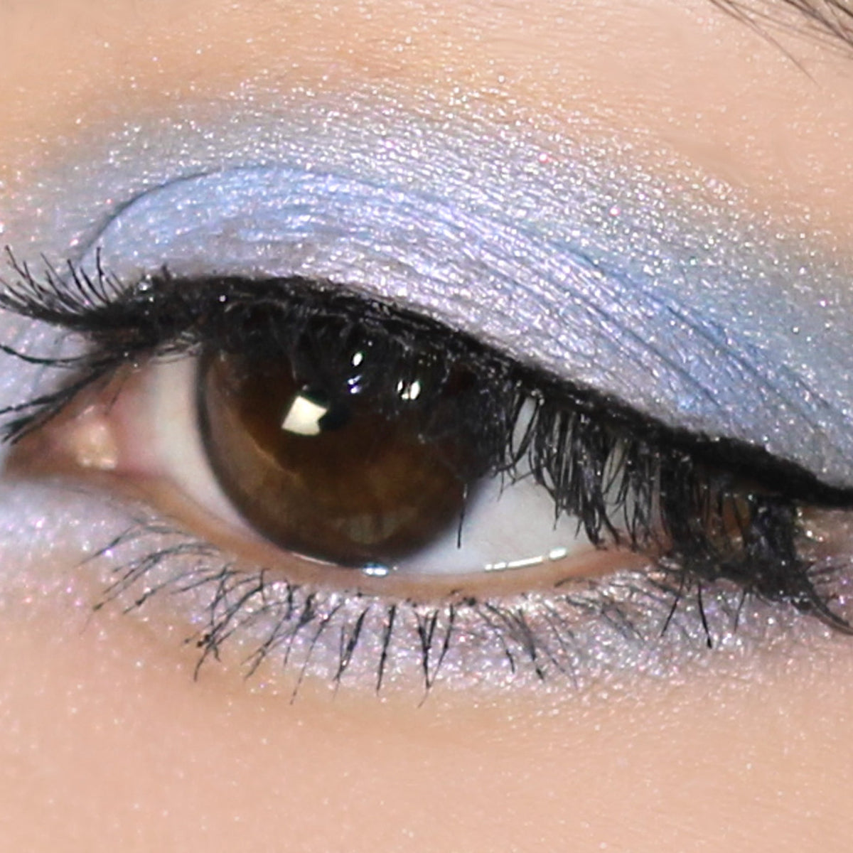 Vibrant blue mineral eyeshadow with pink and turquoise shimmer in compact case