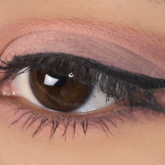 Close-up of matte beige pink mineral eyeshadow swatched on fingertip with soft blended edges