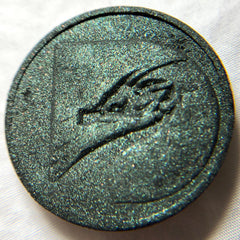 Round metallic teal eyeshadow with embossed design and glitter finish