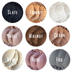 Side view of matte mineral eye shadow loose powder in earthy tones with minimalist eco-friendly packaging