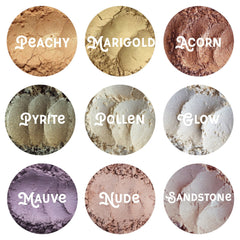 Close-up of loose mineral eye shadow powder in a vegan palette with shimmering earthy tones