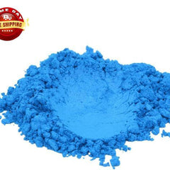 Vibrant blue mica pigment powder in a sleek cylindrical jar with gold lid, showcasing fine shimmer texture.