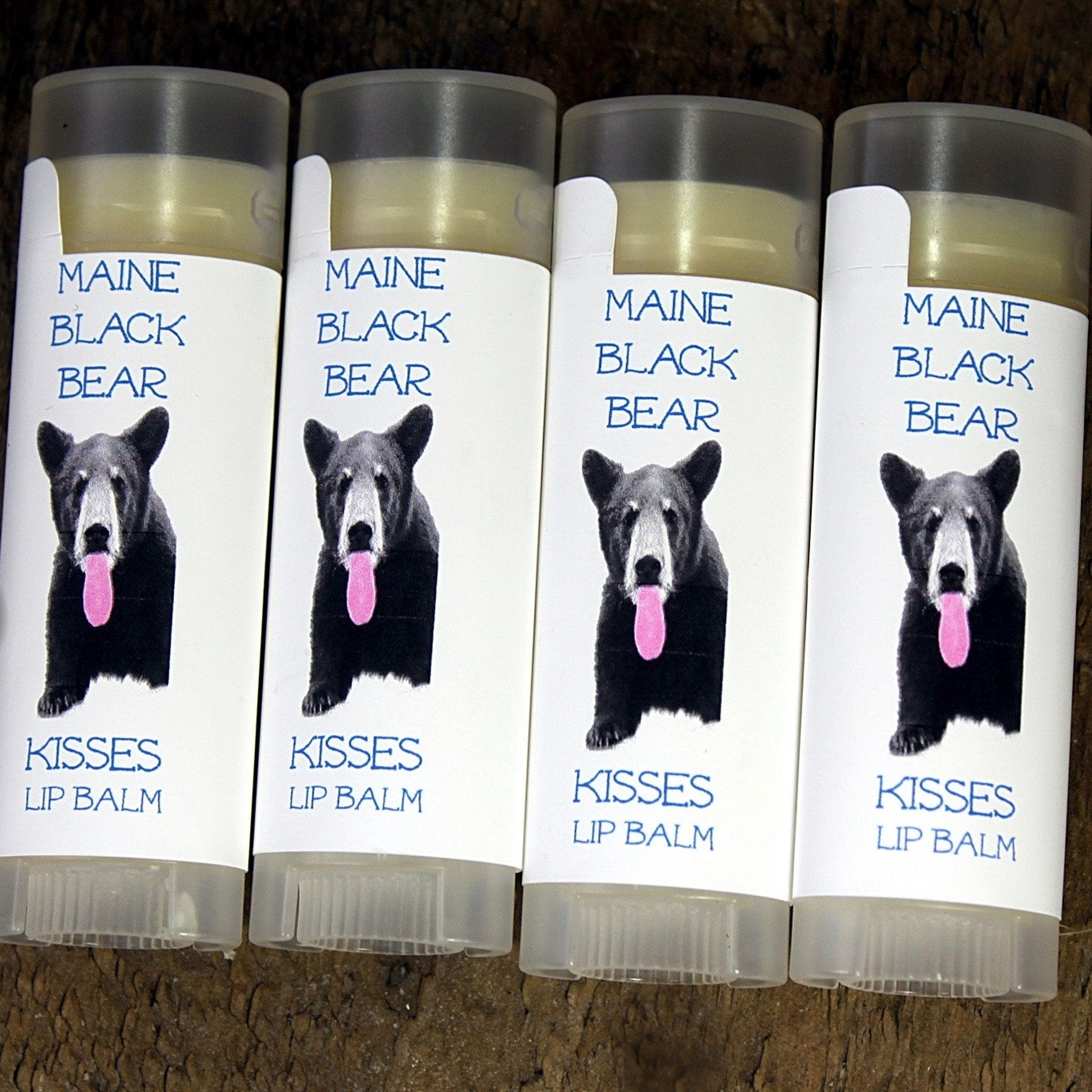 Lip balm tubes with white labels, black bear image with pink tongue, "MAINE BLACK BEAR" text