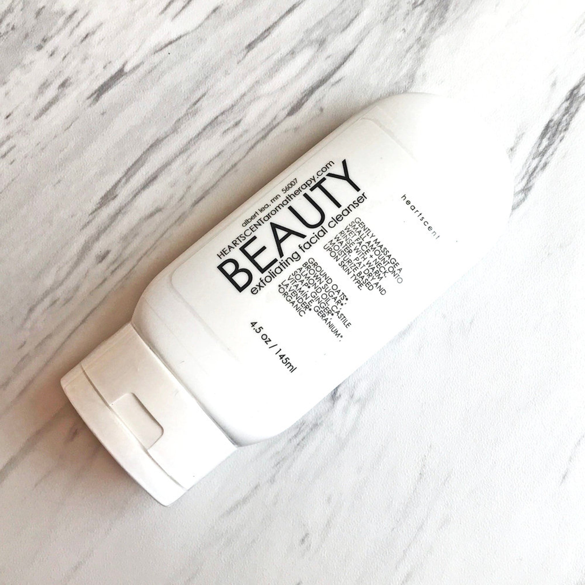 Facial cleanser bottle, white plastic, black text, BEAUTY brand visible on label