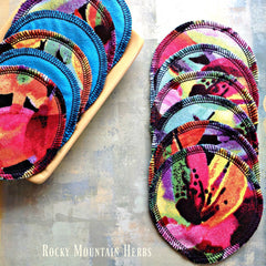 Reusable cotton facial rounds in colorful patterned fabric with black stitched edges, Rocky Mountain Herbs visible