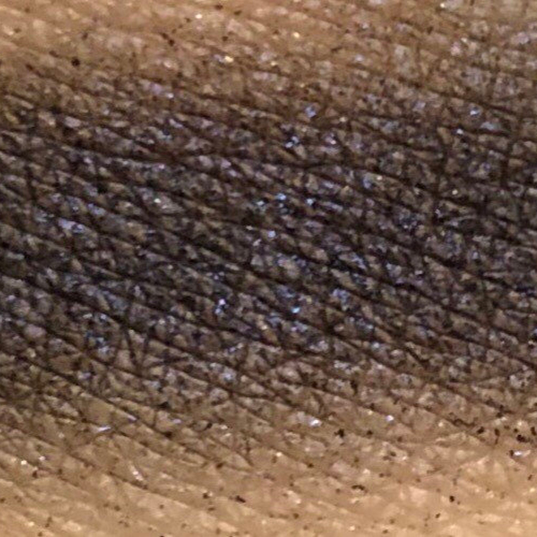 Close-up of fingertips applying pressed mineral eyeshadow in a circular motion to eyelid