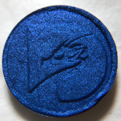 Close-up of pressed mineral eyeshadow pan showing smooth texture and rich pigmentation in a 26mm compact