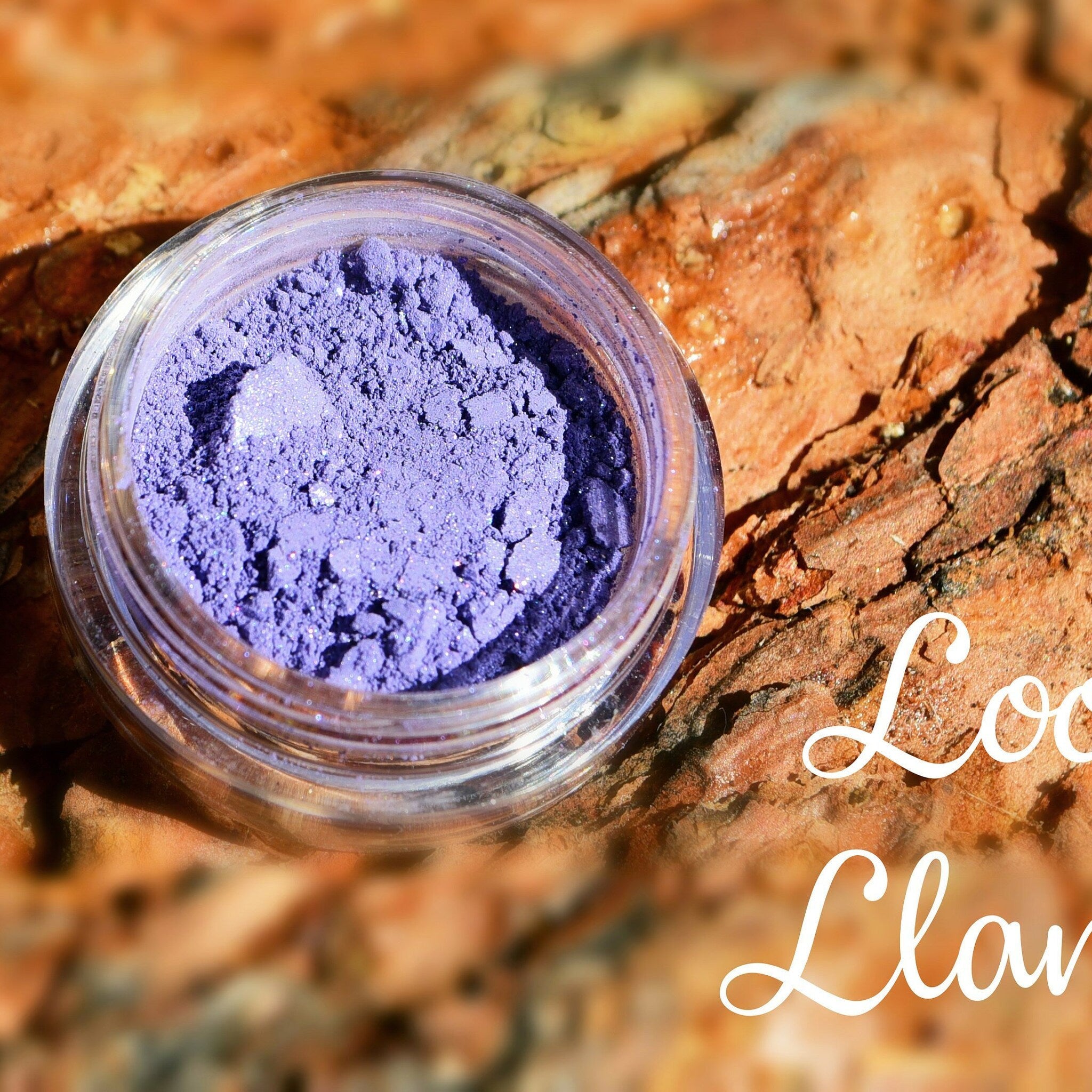 Small glass jar of Loot Llama pigmented mineral eyeshadow with sifter lid in vibrant multicolor shimmery powder
