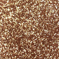 Close-up of Tala Cafe au Lait glitter eye shadow pigment in a small 2ml tube with warm taupe shimmer